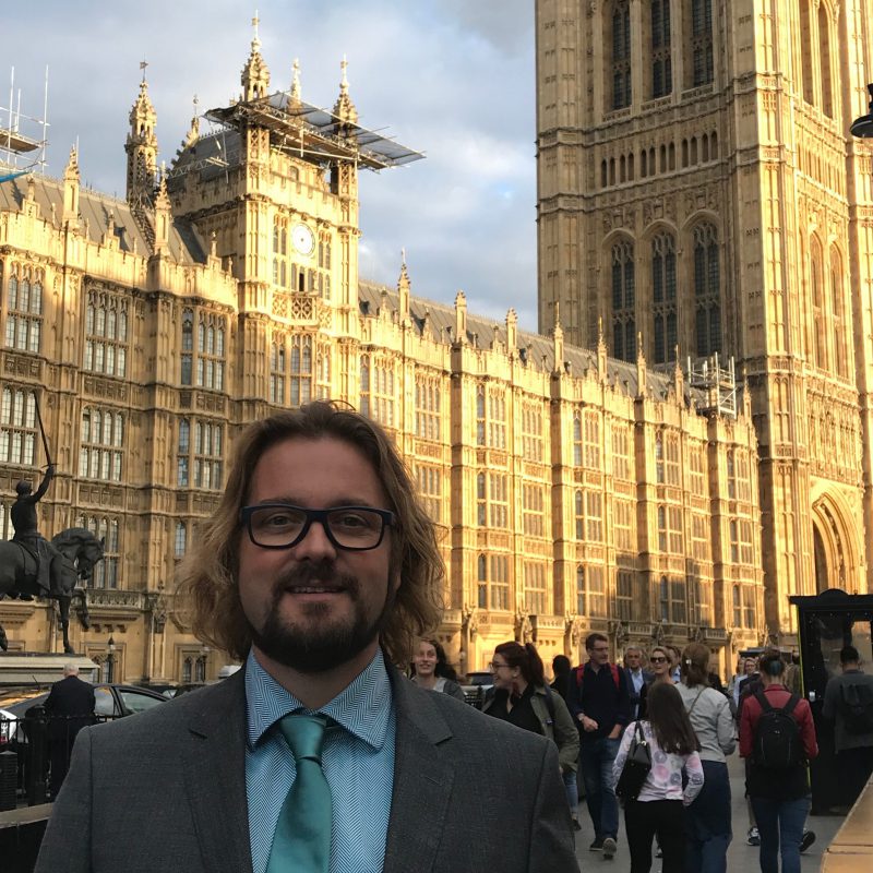 Procurri employee Mat Jordan stands in front of the British parliament building.