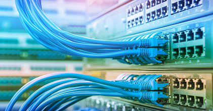 Numerous wires clip in to electrical equipment, with a rainbow coloured hue.